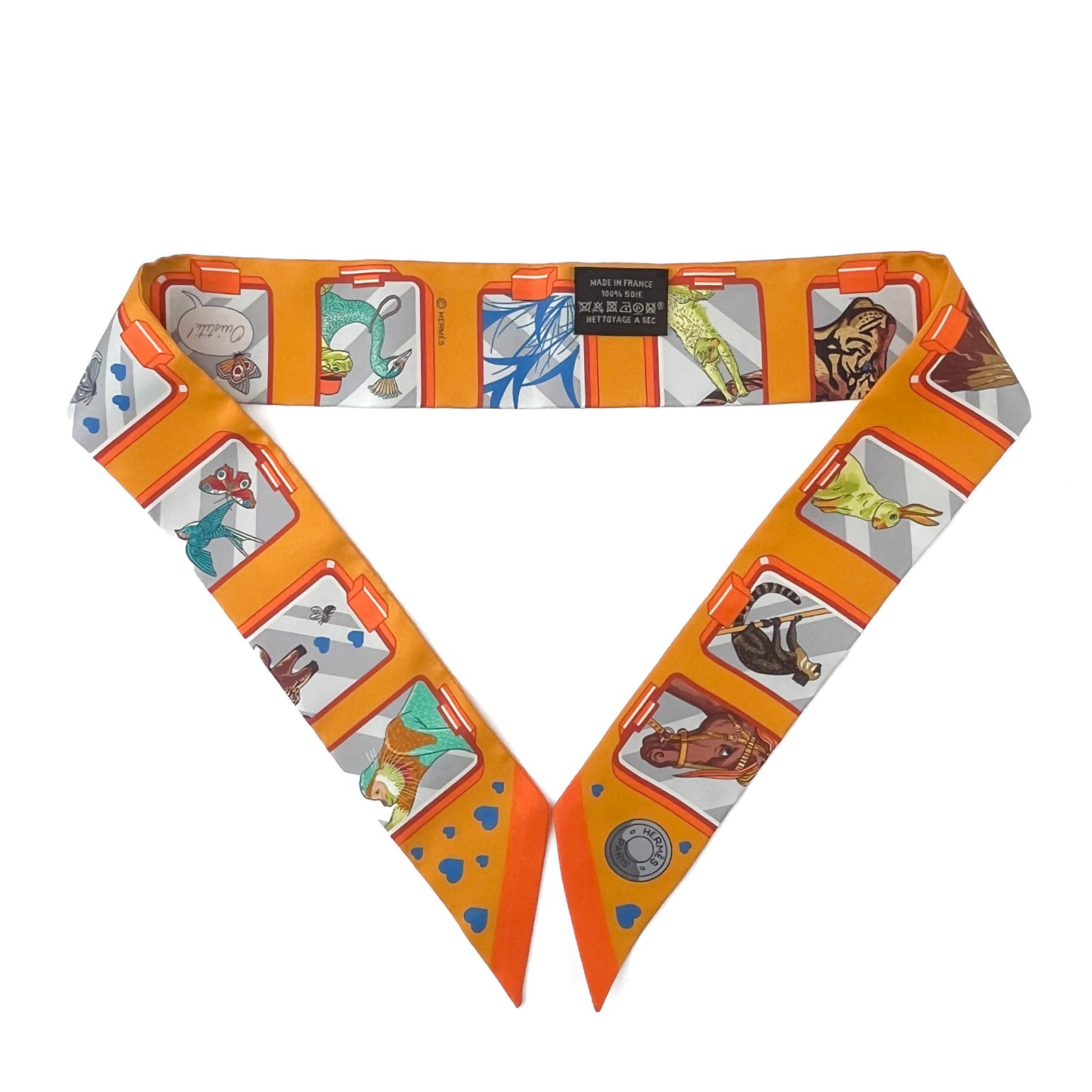 IMG_2693 Vibrant Hermès Story Twilly Scarf in multicolor orange showcasing iconic Hermès symbols.